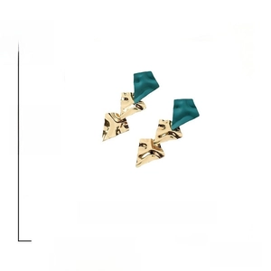 Macro detail of geometric earring with green matte top and gold crinkled metal plates