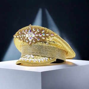 Detailed view of luxury gold sequin captain hat with ornate rhinestone flower design