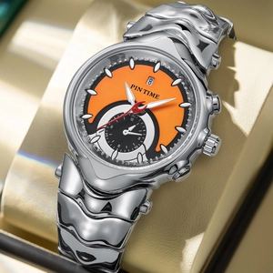 Macro view of silver watch with orange dial on cushion showing date detail