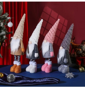 Detailed view of four colorful Nordic Christmas gnomes with knitted hats and soft textures