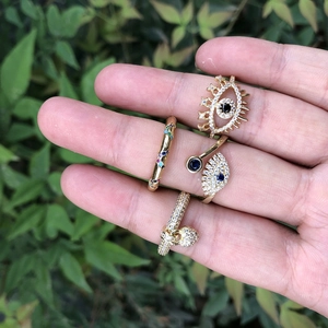 Bohemian gold rings set featuring evil eye designs and colorful zircon crystals