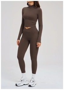 Detail of coffee brown yoga set with zip-up top and V-cross high waist leggings