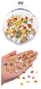 Detailed close-up of mixed Christmas enamel charms including gingerbread man and tree