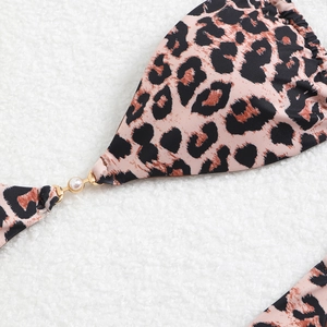 Detail of leopard print bikini top with elegant pearl and gold metal hardware