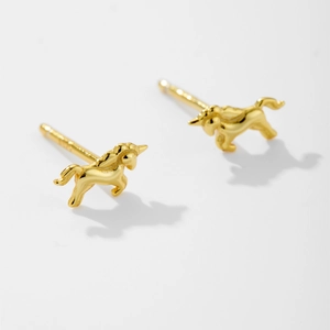 Close-up of golden unicorn stud earrings in 925 sterling silver with a polished finish