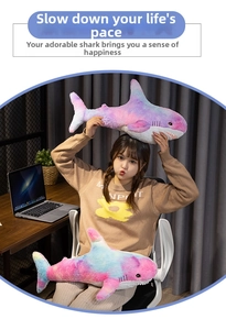 Detailed view of colorful gradient shark plush dolls in two sizes with soft texture