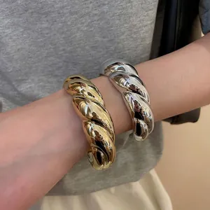 Minimalist twisted metal C-shape cuff bracelet in gold and silver finish for women