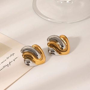 Detail of two-tone geometric stainless steel earrings with a polished wavy overlapping design