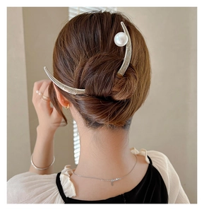 Detailed back view of a crescent hair pin with cloud patterns and a white pearl