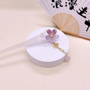 Detail of cherry blossom hairpin with purple flower, tassel, pearl, and golden accents