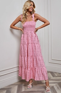 Detail of pink tiered sundress with geometric print and shoulder bow tie accents