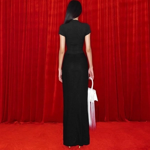 Rear view of a tight black short sleeve maxi dress with back seam detailing
