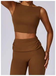 Close-up of brown high-waisted yoga leggings with draped waistband and seamless fabric