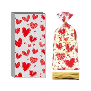 Detailed view of clear heart print candy bags with gold twist ties for festive gift packaging