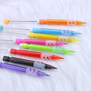 8-color DIY beaded mechanical pencils with glitter finish on textured white plush surface