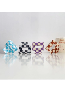 Close-up of checkerboard hair claws in blue, black, purple and caramel glossy finish