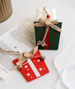 Detail of wooden Christmas ornaments with linen rope and bell on vintage paper