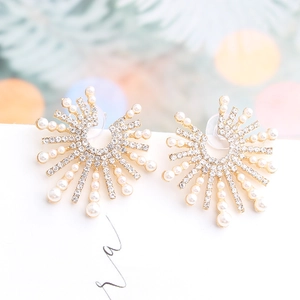 Golden sunburst earrings with white pearls and sparkling rhinestones on card