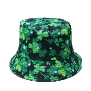 Detailed view of St. Patrick's Day bucket hat with green shamrock print on black fabric