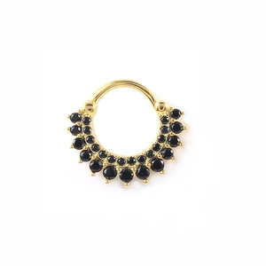 Close-up of golden nose ring with double row of black round zircon gemstones on white background