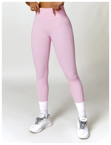 Detail view of pink high-waisted compression yoga leggings with seamless sculpting effect