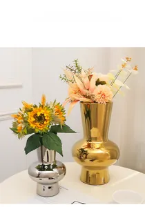 Detail of modern mirrored silver ceramic vase showing reflective surface and sleek design