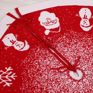 Knitted red and white Christmas tree skirt with festive Santa and snowman patterns