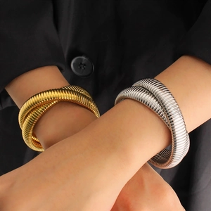 Detailed close-up of gold and silver spring tube snake-patterned elastic bracelets