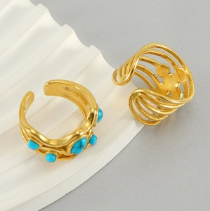 Detail of vintage 18k gold plated stainless steel rings with turquoise floral accents