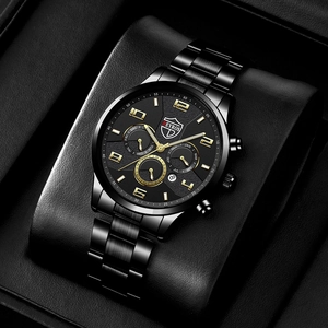 Macro view of a black stainless steel watch dial with gold markers in a leather gift box