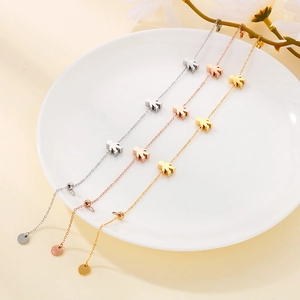Detailed view of polished stainless steel bracelets with cute stick figure charms in three colors