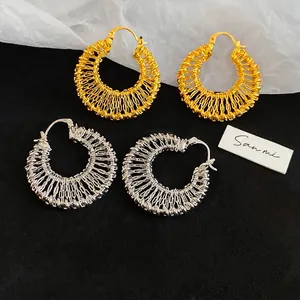18k gold plated hollow woven hoop earrings with intricate metallic mesh design texture