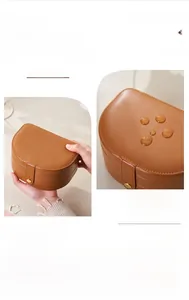 Detail view of water-resistant brown leather jewelry box with multi-layer storage sections