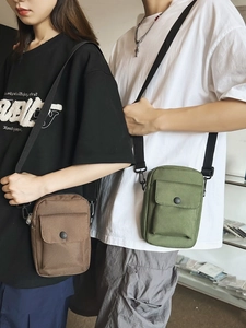 Street style canvas crossbody bags in brown and green with adjustable shoulder straps