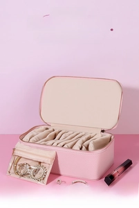 Detail of pink PU leather jewelry box with multiple compartments and internal zipper pouch