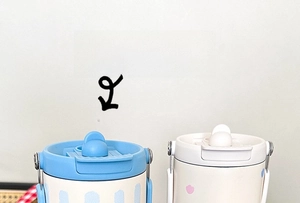 Close-up of dual-color insulated tumbler lids featuring straw ports and carry straps
