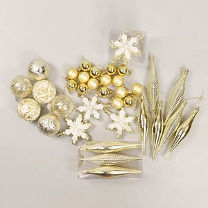 Golden Christmas ornament set with glittery balls and snowflakes on a grey background