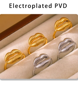 Detail view of gold and silver smiling lip rings with PVD plating in a velvet jewelry box