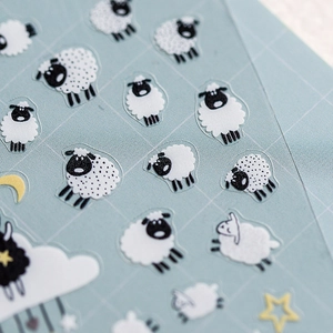 Matte cartoon sheep nail stickers with moon and stars on light blue grid background