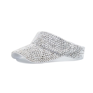 Macro shot of white sun visor hat with sparkling rhinestones and elegant fabric texture