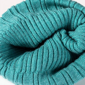 Teal knitted winter beanie hat with thick ribbed texture and warm folded cuff detail