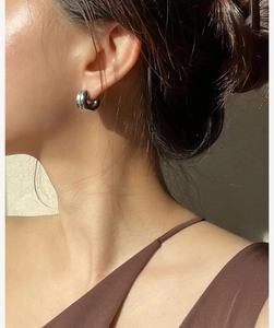 Close-up of minimalist silver double C-shaped hoop earrings on female model