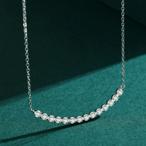 Elegant S925 sterling silver curved diamond necklace displayed on green surface
