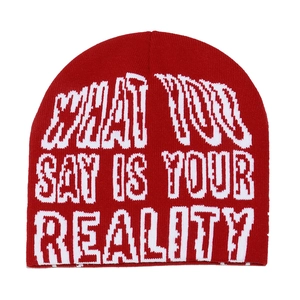 Close-up of red knit beanie featuring white letter jacquard and high elasticity texture