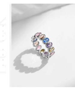 Detail of eternity band featuring colorful oval-cut cubic zirconia in a silver setting