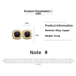 Detail view of retro square earrings featuring gold textured frames and black round stones