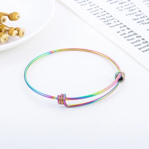 Detail view of rainbow gradient stainless steel wire bracelet on aesthetic background