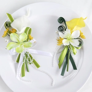 Elegant white and yellow calla lily wedding boutonnieres with pearls on white plate