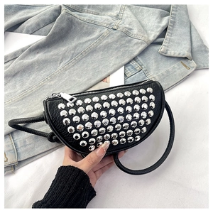 Detail of black pebbled leather crescent bag with silver stud rivets and a zipper closure