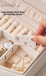 Detail showing the removable earring bar and velvet interior of the jewelry box